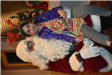 Girl Wearing Antlers Poses with Santa