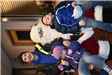 Three Siblings Pose for a Photo with Santa