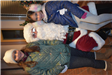 Two Girls Smile for a Photo with Santa