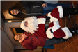 Two Women Take a Picture with Santa