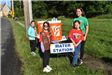 Volunteers at a Water Station Alongside the Road