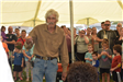 Man Holding a Gecko at an Animal Show