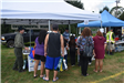 People Checking out the Environmental Board Tent