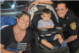 Police Officer and Mom Take a Photo with Her Kid in a Stroller