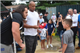 Athlete Signing a Hat for a Young Boy