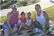 Mothers and Daughters Having A Picnic Near a Sidewalk