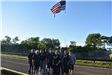 Police Officers and Volunteers Standing Below the American Flag 1