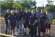 Police Officers and Volunteers Standing Below the American Flag 2