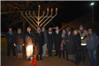 Special Guest Take a Picture in Front of the Town Menorah