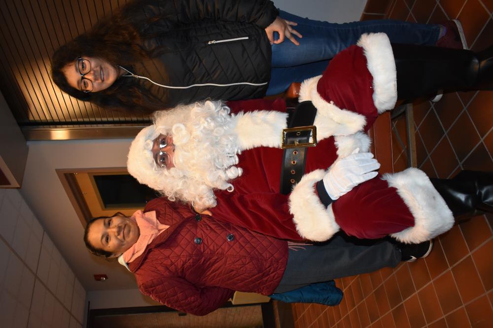 Two Women Take a Picture with Santa