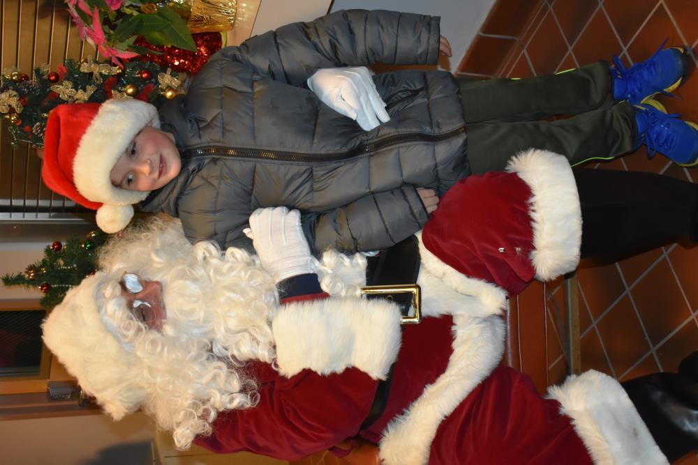 Boy in a Grey Coat Sitting on Santa's Lap
