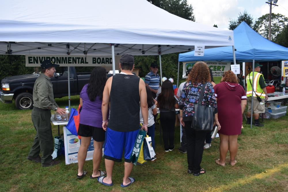 People Checking out the Environmental Board Tent