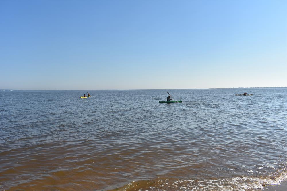 People Kayaking Far from the Shore
