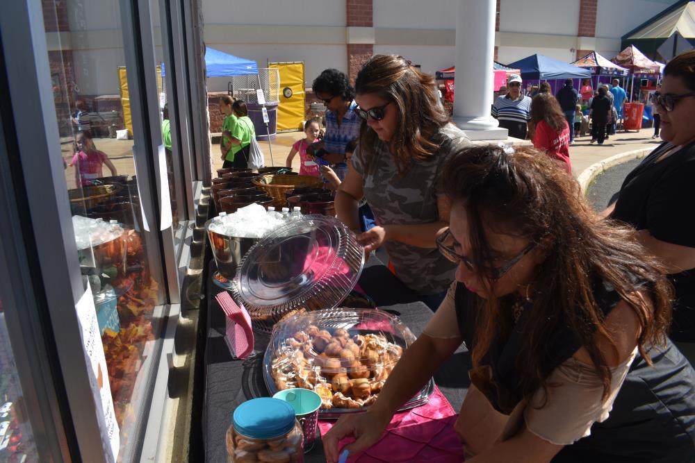 People Lined up at a Refreshments Table