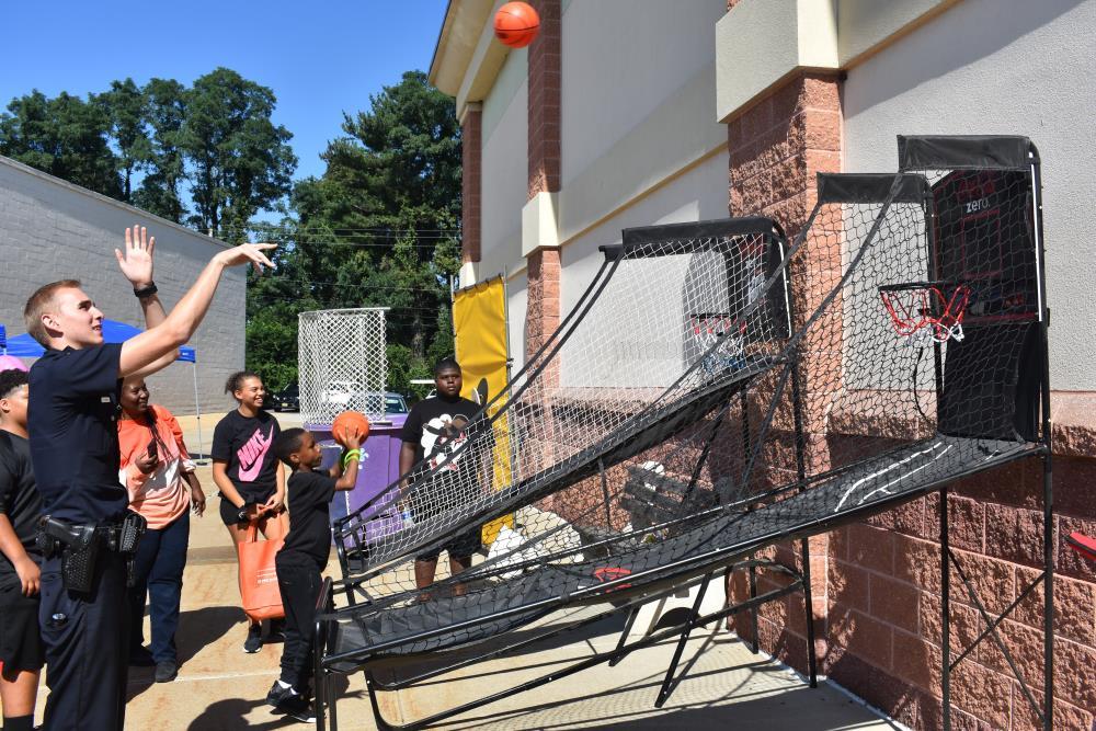 Police Officer Tossing a Basketball