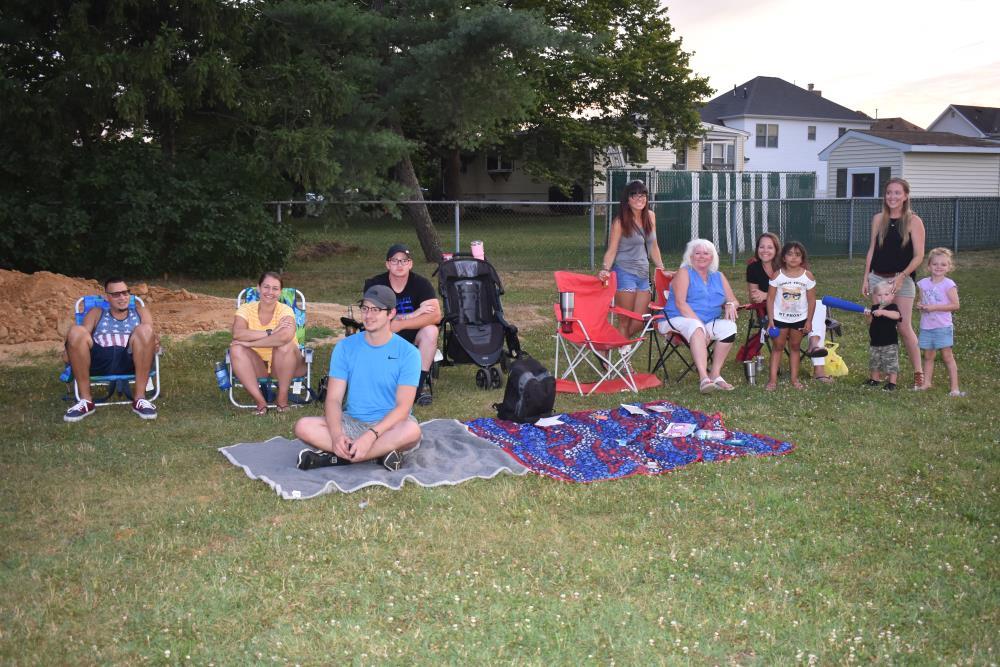 Various Spectators Watch from Lawn Chairs and Blankets on the Ground