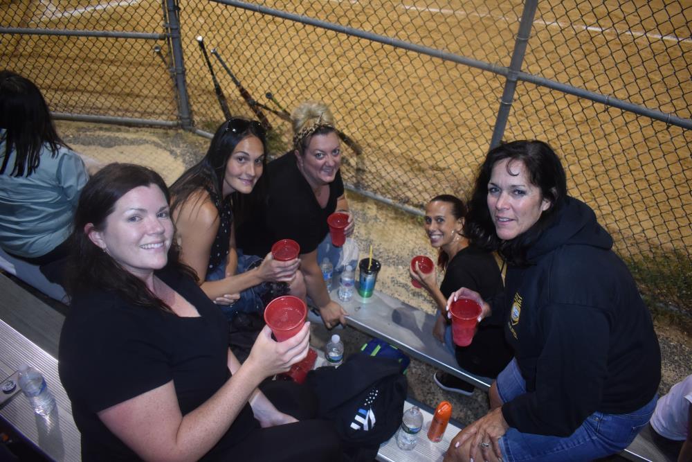 Women with Drinks Toast Towards the Camera