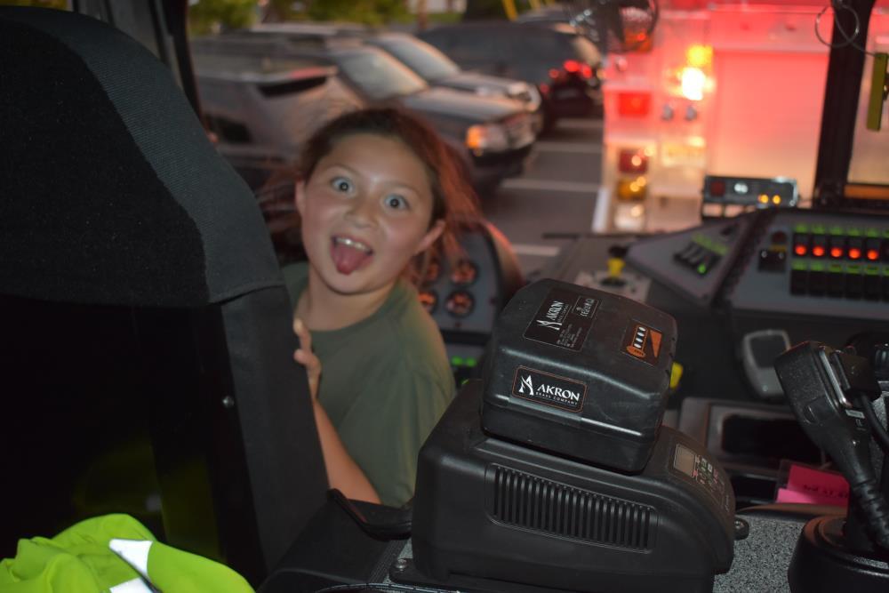Girl Making a Funny Face from the Cab of a Fire Truck