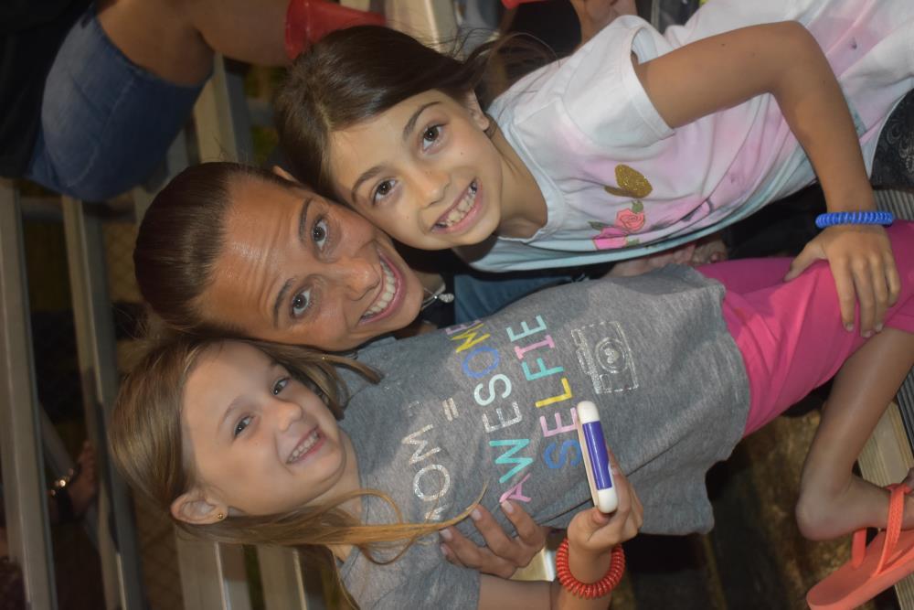 Mom and Her Daughters Sile for Their Picture