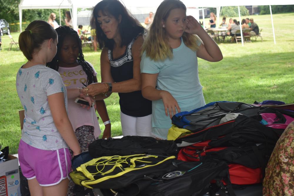 Volunteer Handing out Backpacks