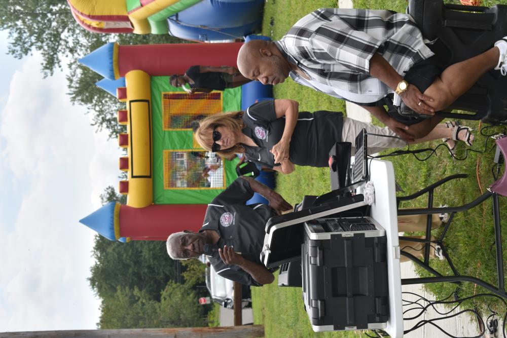 Council Members Emcee near the Bounce House
