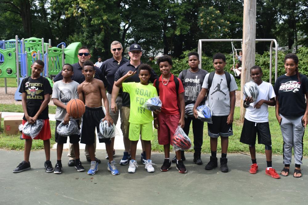 Group of Kids Pose for a Group Photo with Some Police Officers