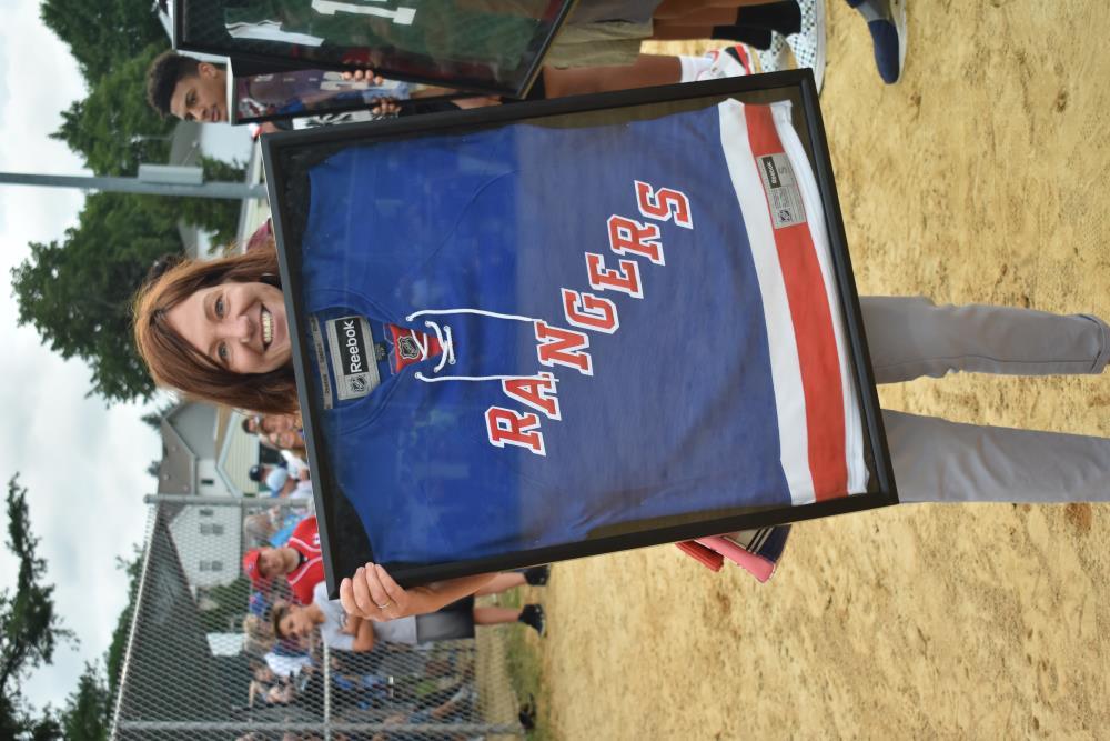 Woman Holding a Framed Rangers Jersey