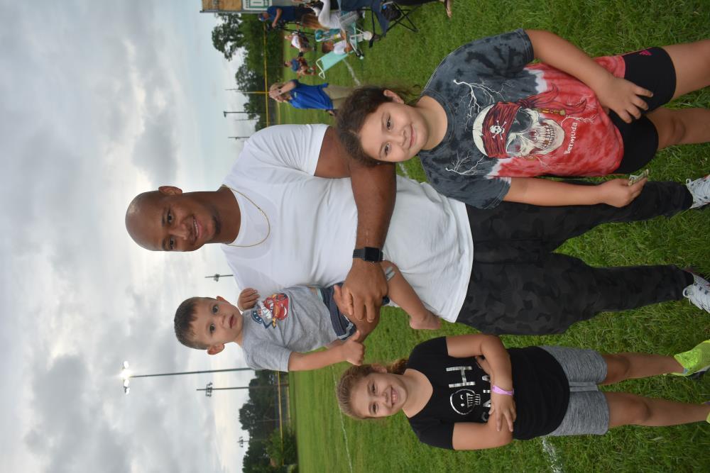 Athlete Has His Photo Taken with Two Young Girls and a Toddler 2