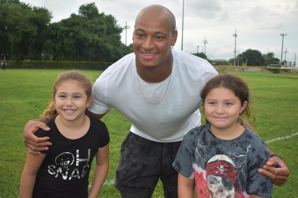 Athlete Has His Photo Taken with Two Young Girls