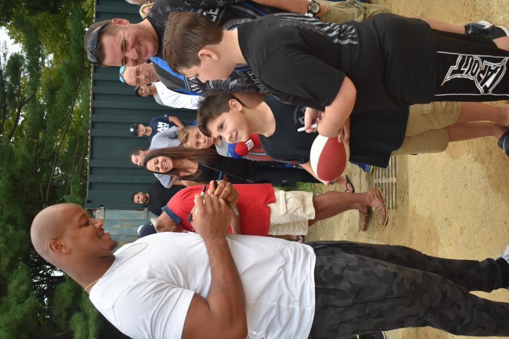 Athlete Signing a Ball for a Young Boy