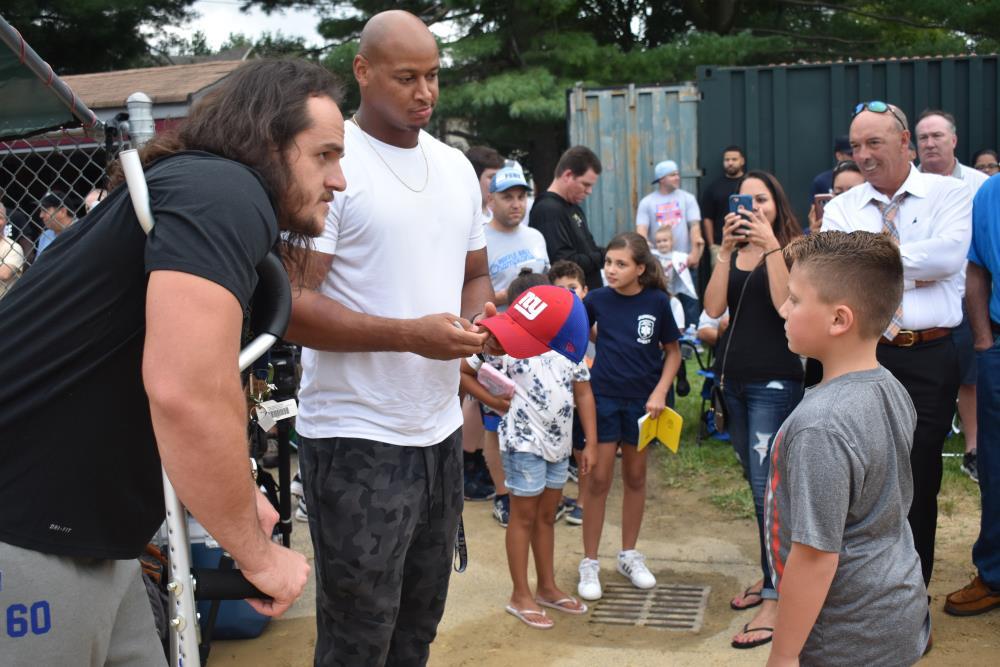 Athlete Signing a Hat for a Young Boy