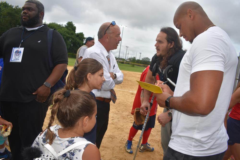Athlete Signing His Autograph for a Young Girl