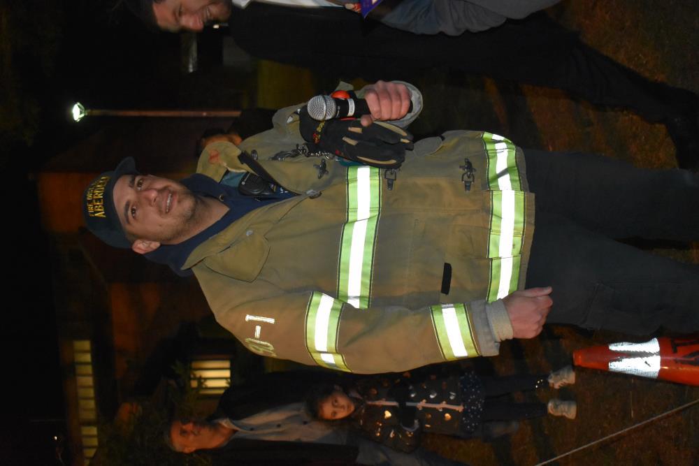 A Local Fire Fighter Makes a Speech at the Menorah Lighting
